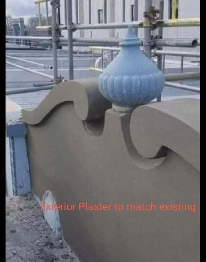 Restored decorative plaster ornament on a heritage building