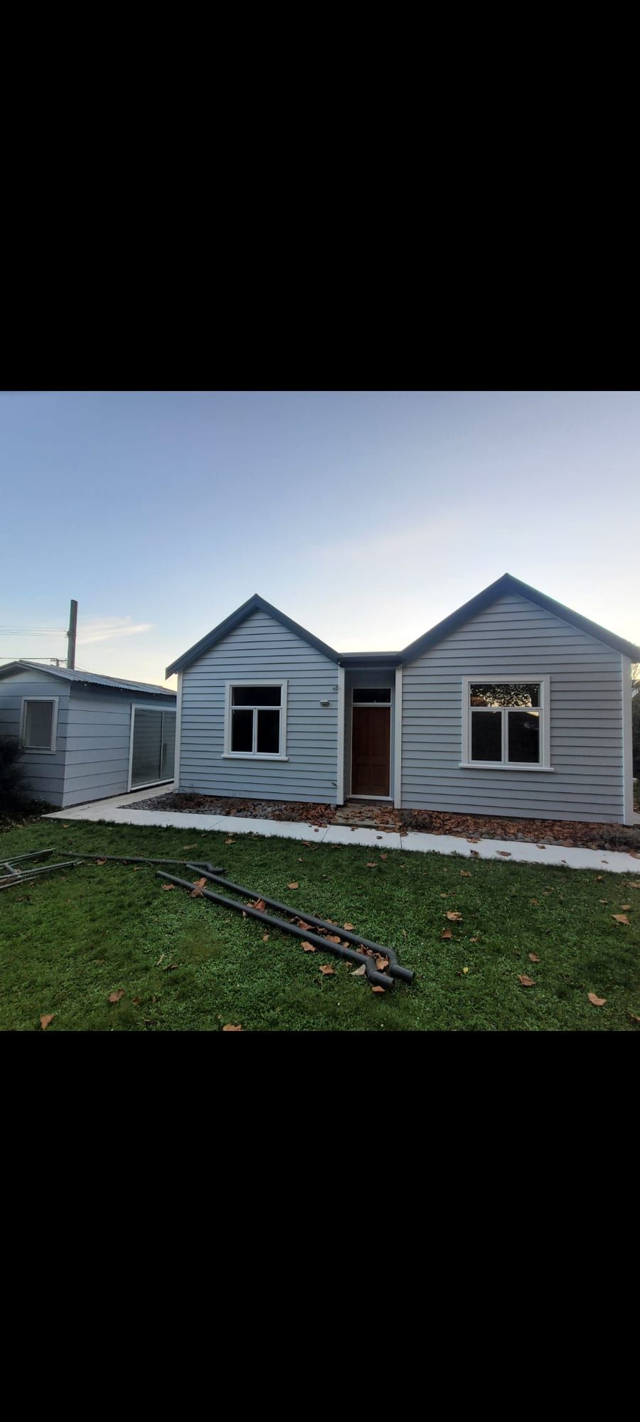 Heritage Christchurch home repainted in cream with a dark gable