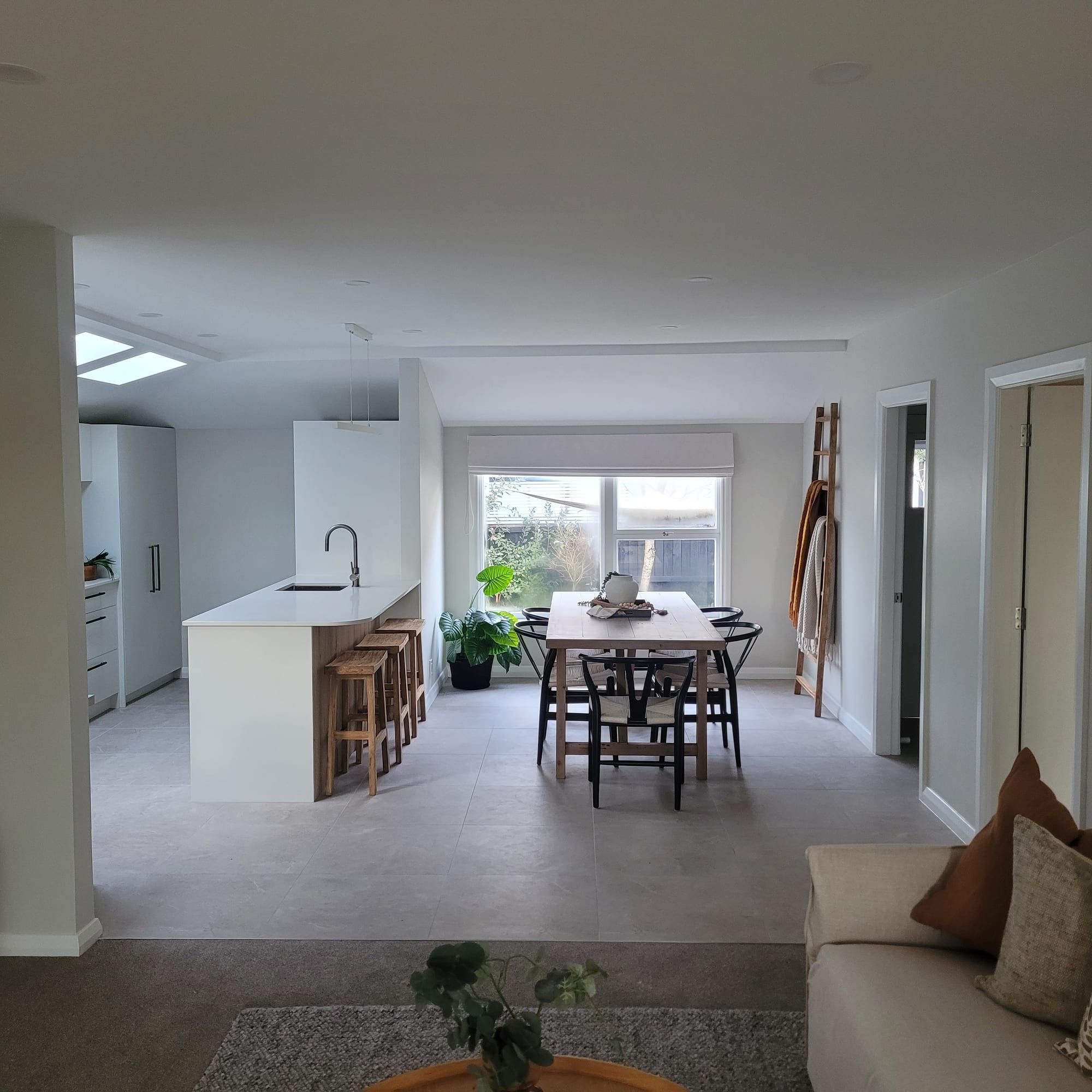 Open-plan kitchen and living repainted in warm white